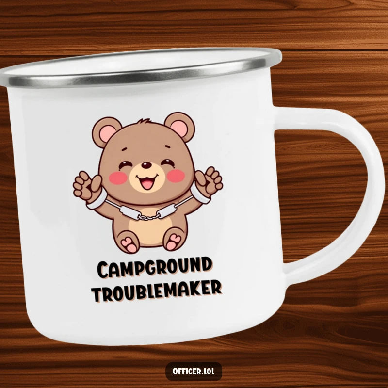 Funny camping mug of a cheerful bear wearing miniature handcuffs, smiling and waving, ready for outdoor fun.